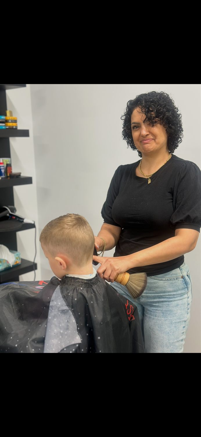Barber cutting a young boy's hair